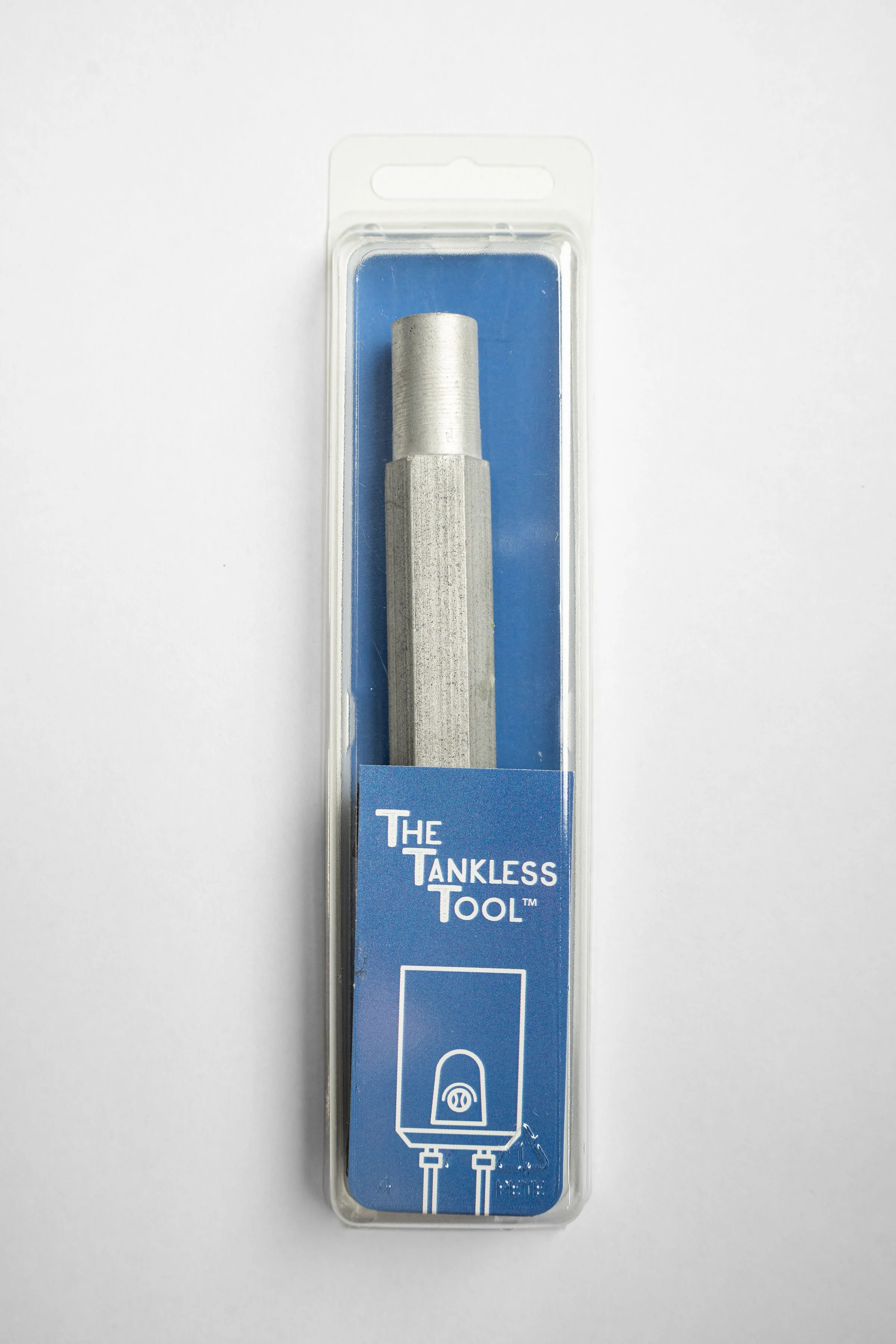 A metal tool called the Tankless Tool inside a clear plastic case with a blue background and a white line drawing of a tankless water heater.