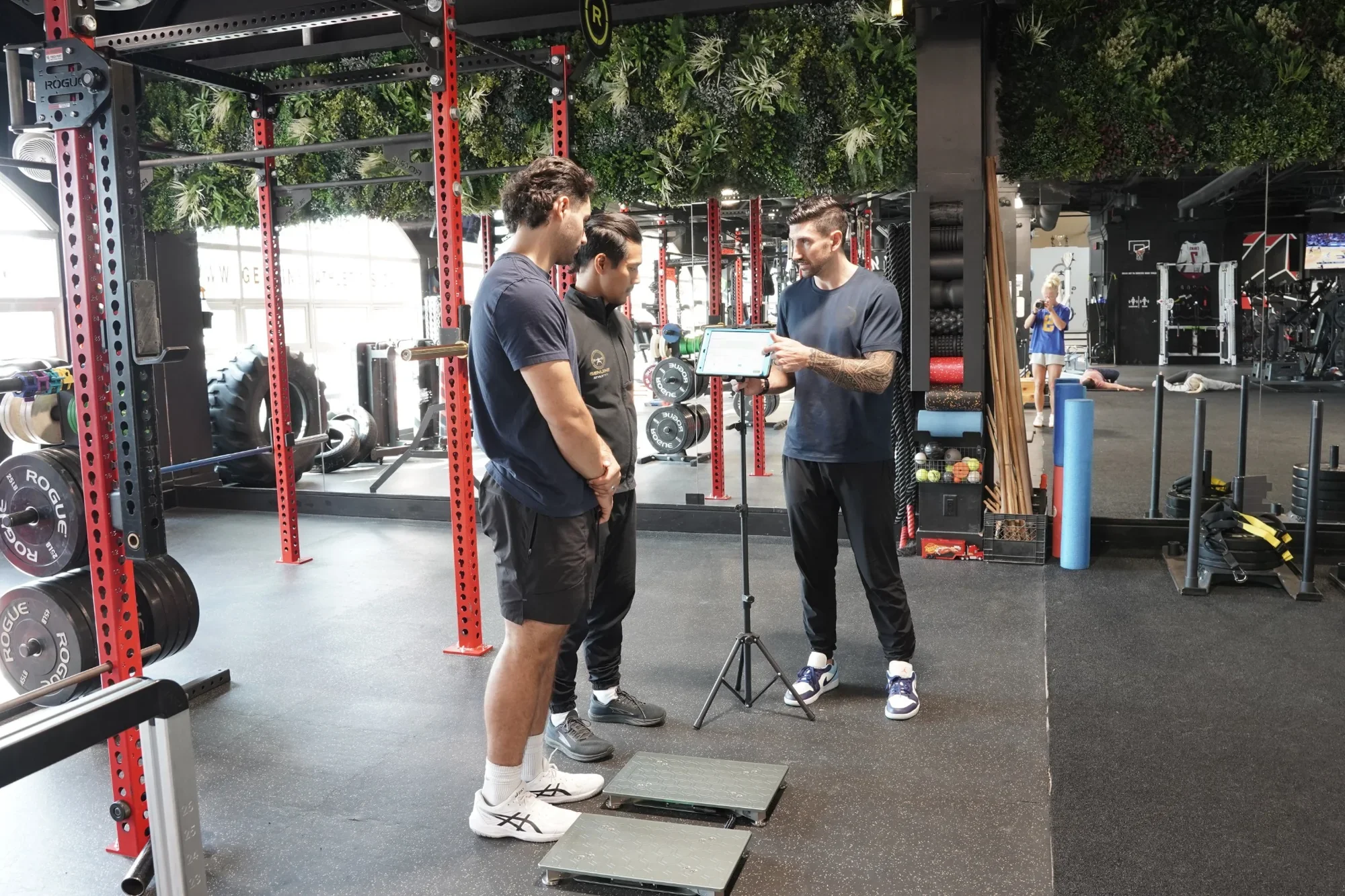 Physiotherapists reviewing ForceDecks testing data during a rehab-to-performance assessment at Genuine Athletics.