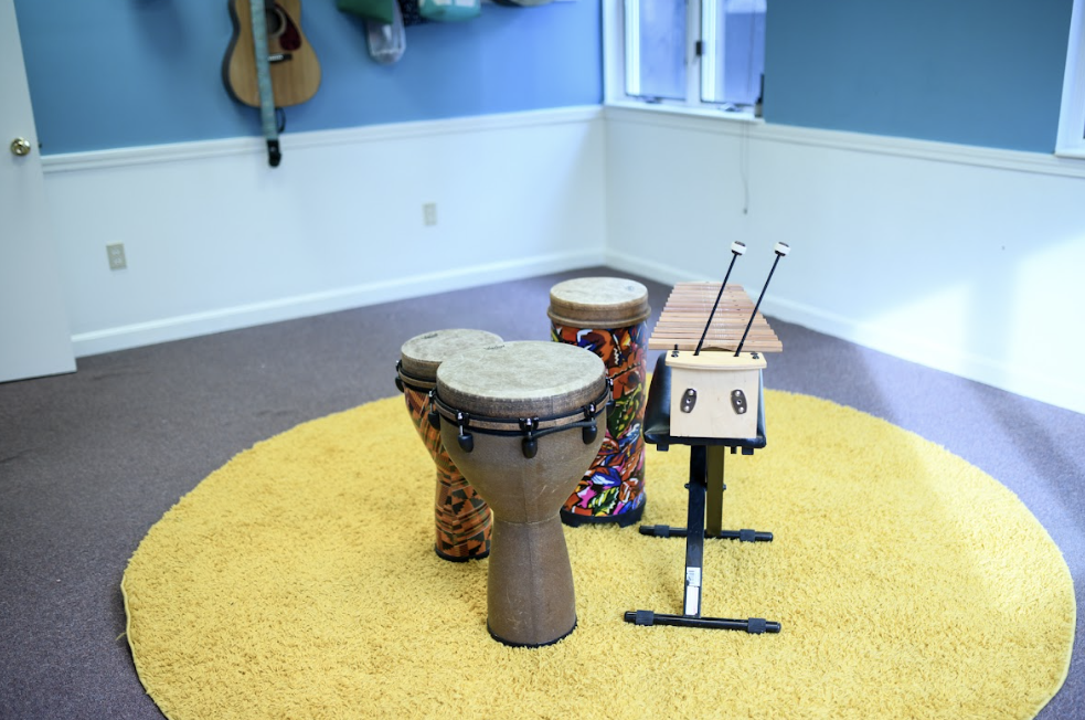Djembe drums and xylophone arranged in a music therapy room at The Sonatina Center in Dover, NH