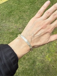Love Note bracelet worn top view.jpeg