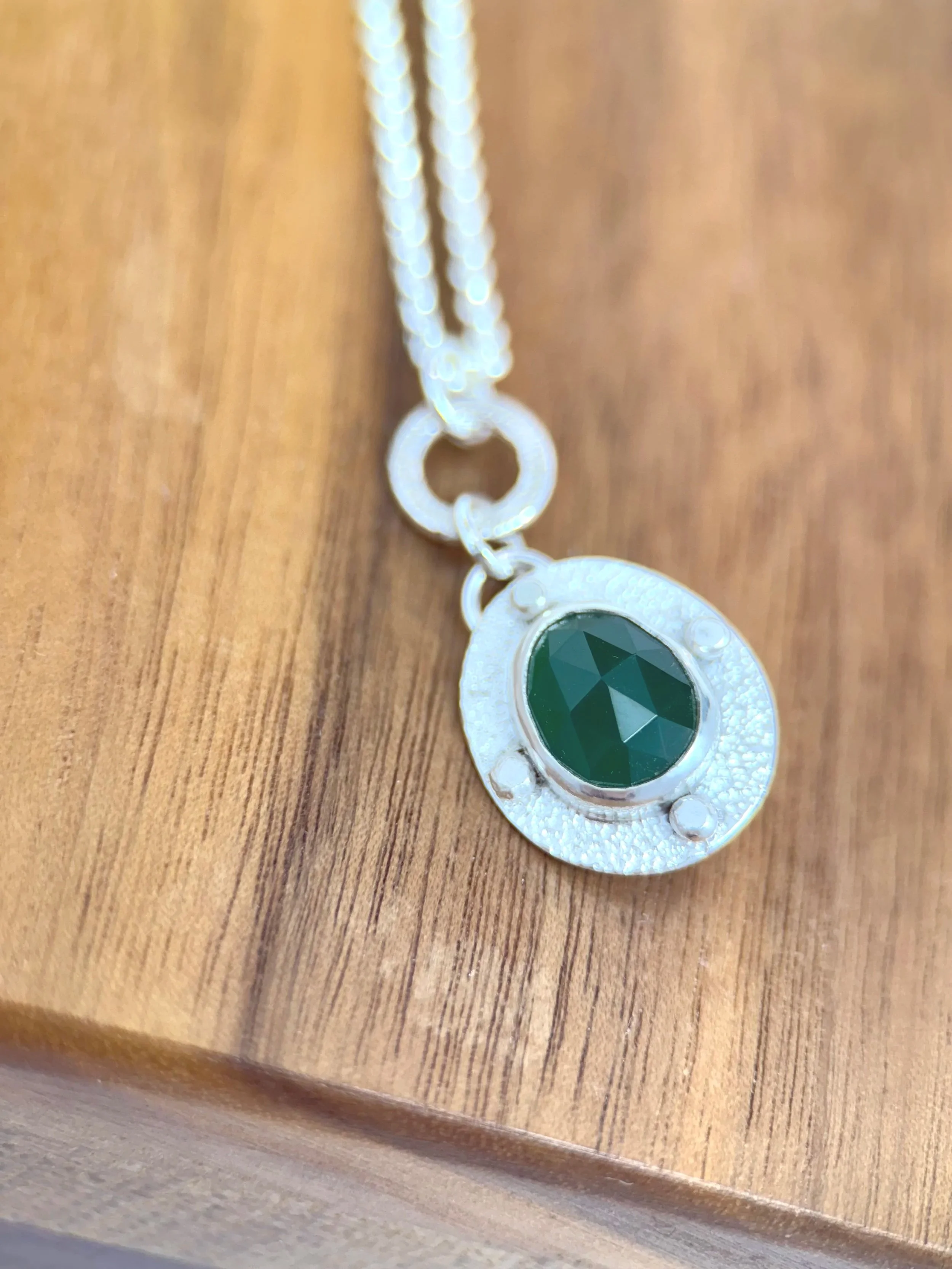 Handcrafted sterling silver pendant with a rose-cut green onyx stone