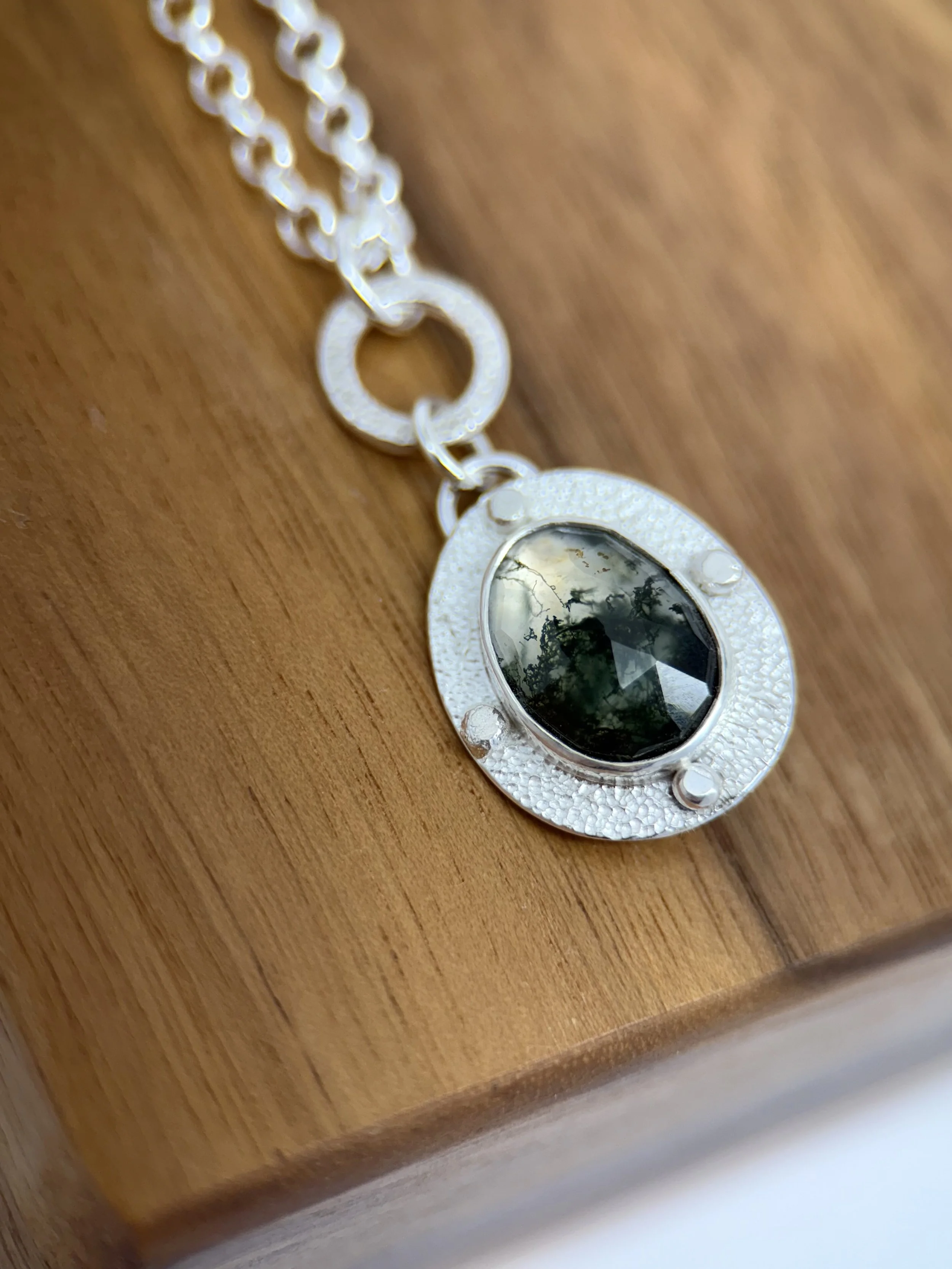 Modern Relic Pendant moss agate close up on wood.jpg