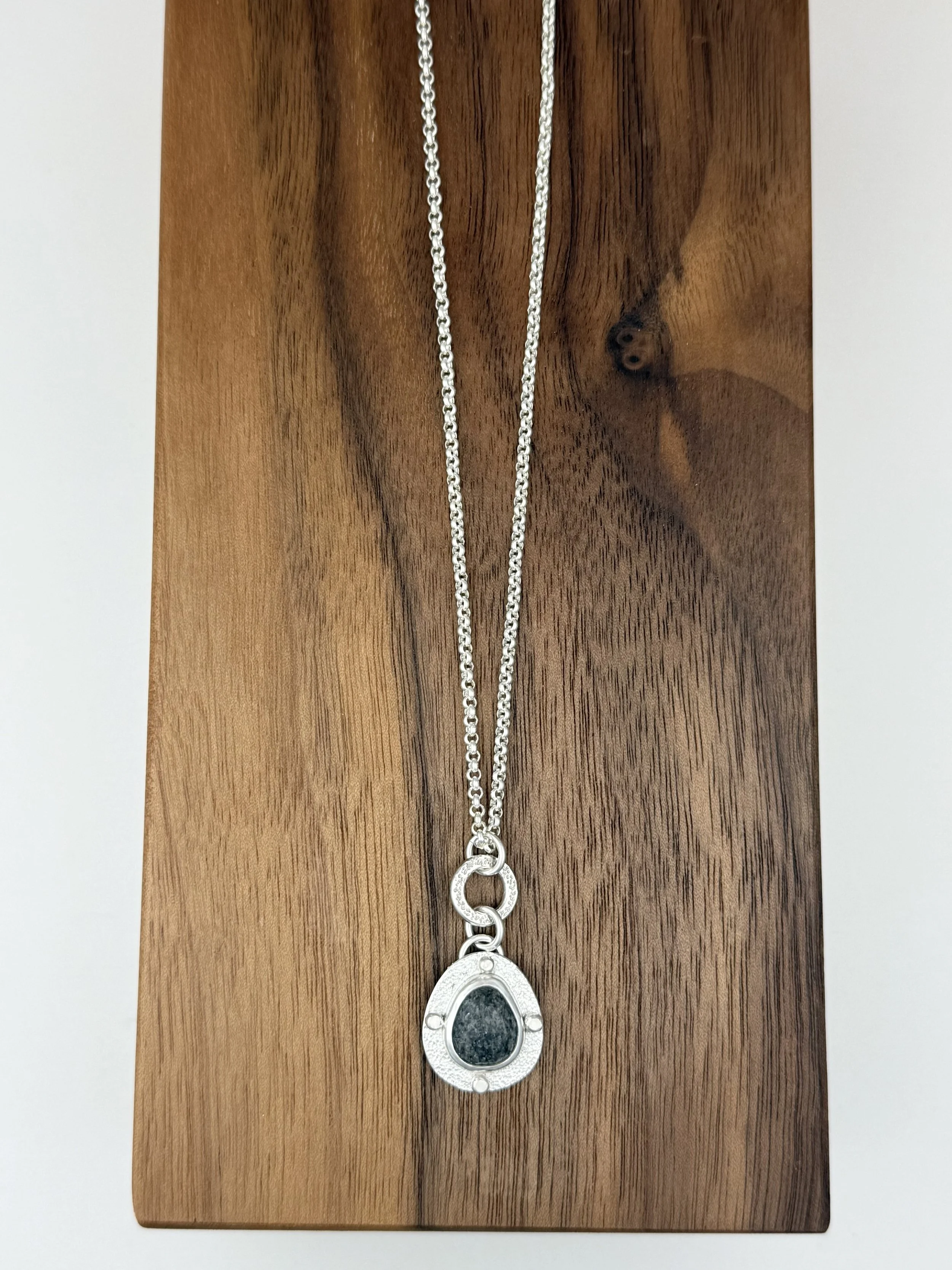 Modern Relic Pendant black aventurine lying flat on wood.jpg