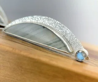 Close-up of a Stormbreak Earring showing natural Saturn Jasper markings, hand-textured sterling silver and bezel-set labradorite