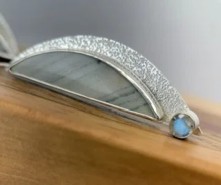 Close-up of a Stormbreak Earring showing natural Saturn Jasper markings, hand-textured sterling silver and bezel-set labradorite