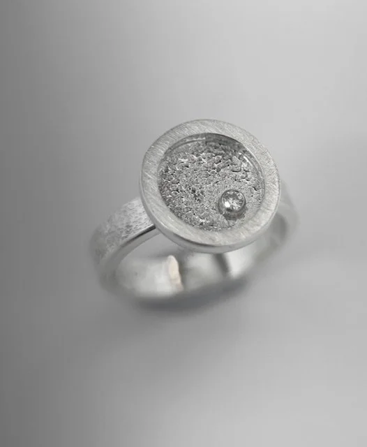 KFinn Designs Lumen Ring with moissanite standing up on white background.jpg