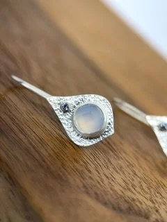 Close-up of Mini Opulence Earrings with luminous blue chalcedony set in hand-textured sterling silver