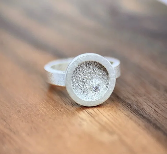 KFinn Designs Lumen Ring with moissanite close up on wood.jpg