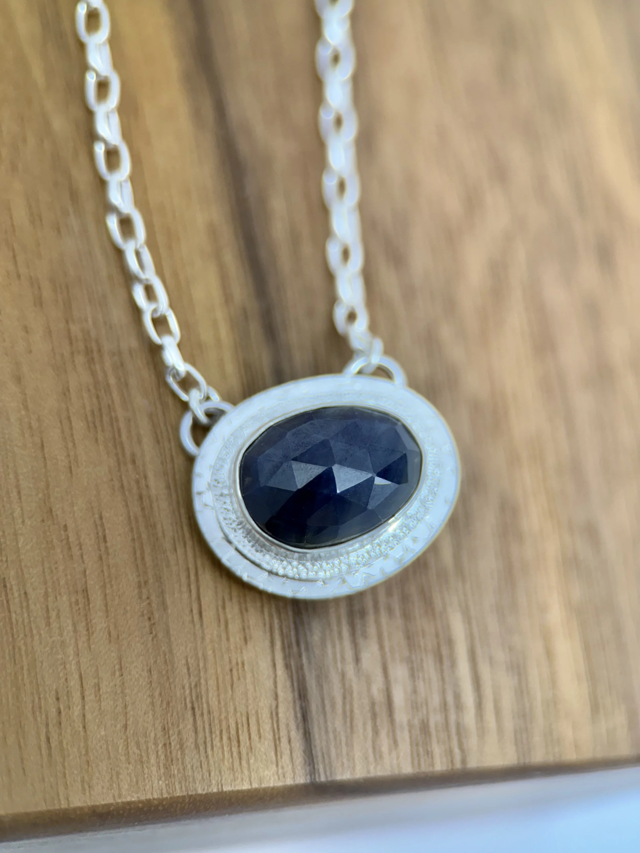 Portal Pendant Sapphire close up on wood better pic.jpg