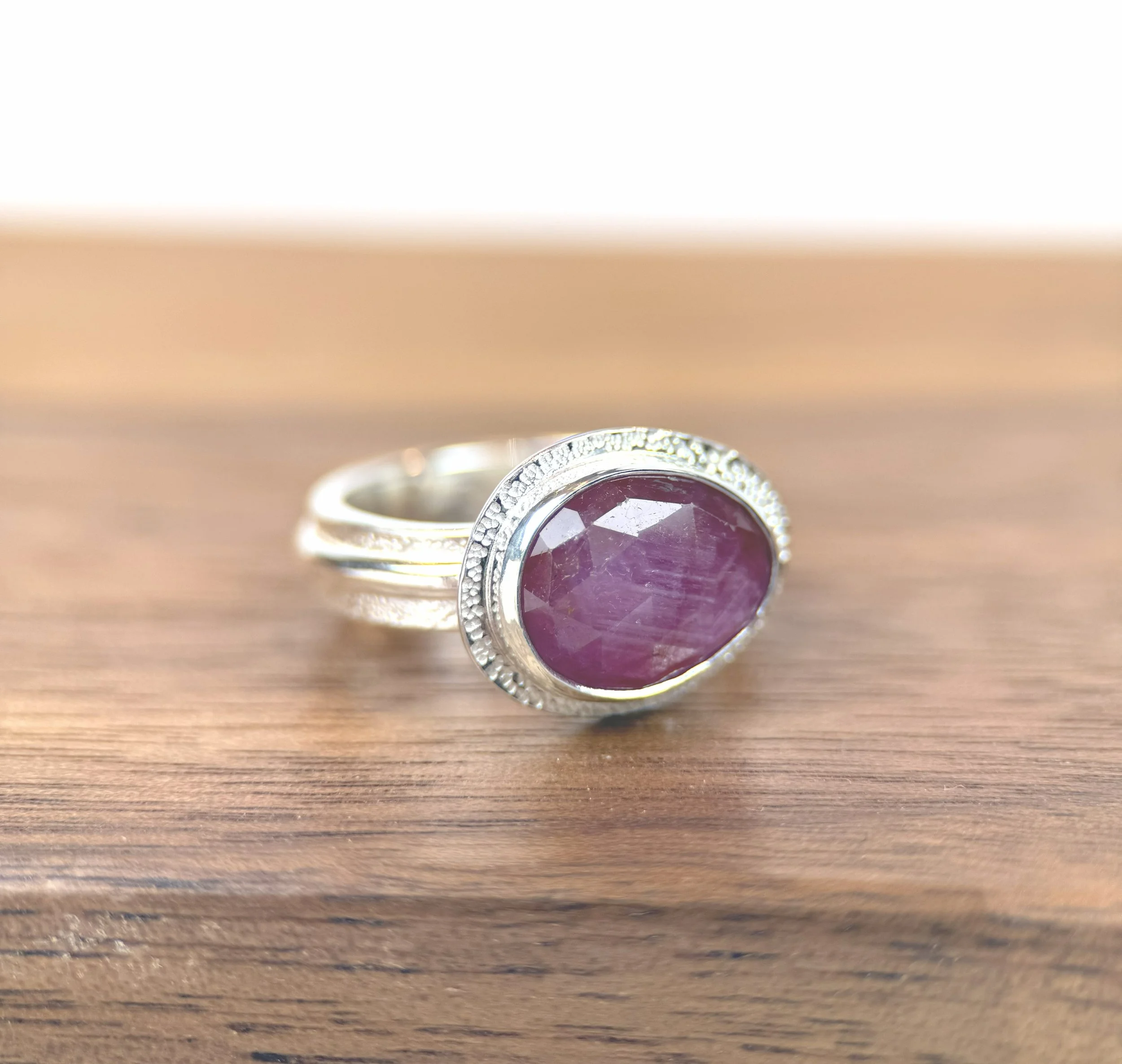 Bauble Ring Pink Sapphire side on wood.jpg