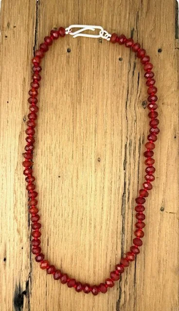 Heirloom Carnelian necklace lying flat on wood.jpeg