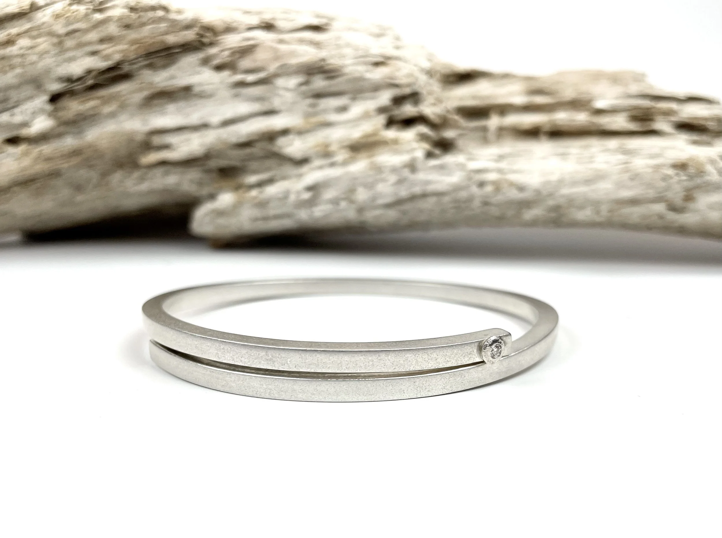 Modern handcrafted Wrapped Bangle in sterling silver with a clean split design and single gemstone detail designed by KFinn Designs for timeless elegance and everyday luxury.