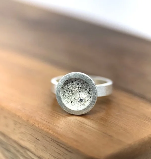 KFinn Designs Lumen Ring with moissanite side view on wood.jpg