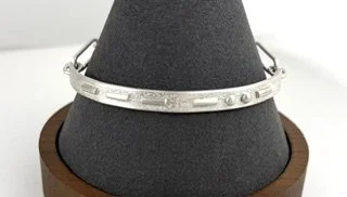 Love Note Bracelet front view on gray stand.jpeg