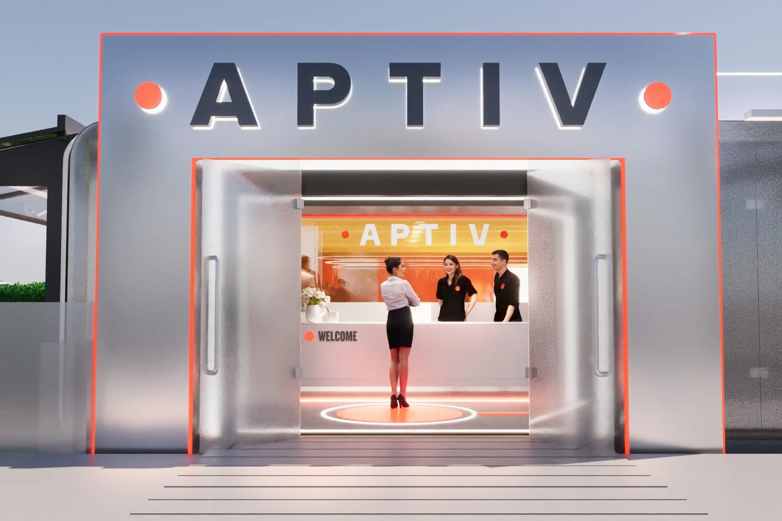 Modern airport lounge entrance with signage 'APTIV', welcoming staff behind counter, woman in business attire talking to staff, illuminated interior with orange and white lighting.