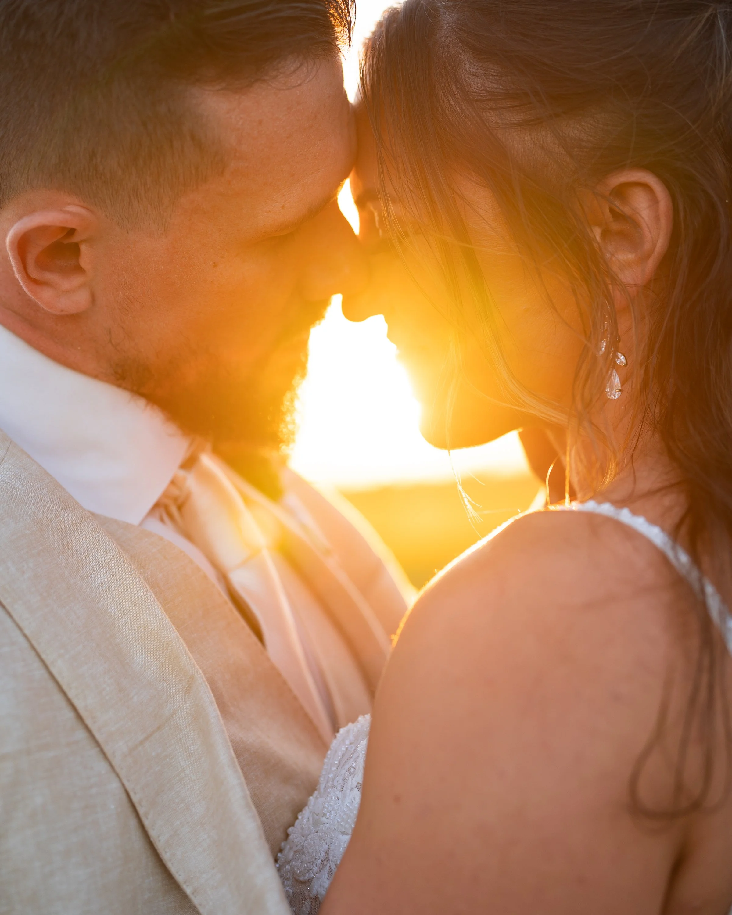 Finley Wedding of bride and groom sharing intimate moment during sunset. Captured at Heban’s Field Of Dreams in Grand Rapids, Ohio, by Colbis Photo 