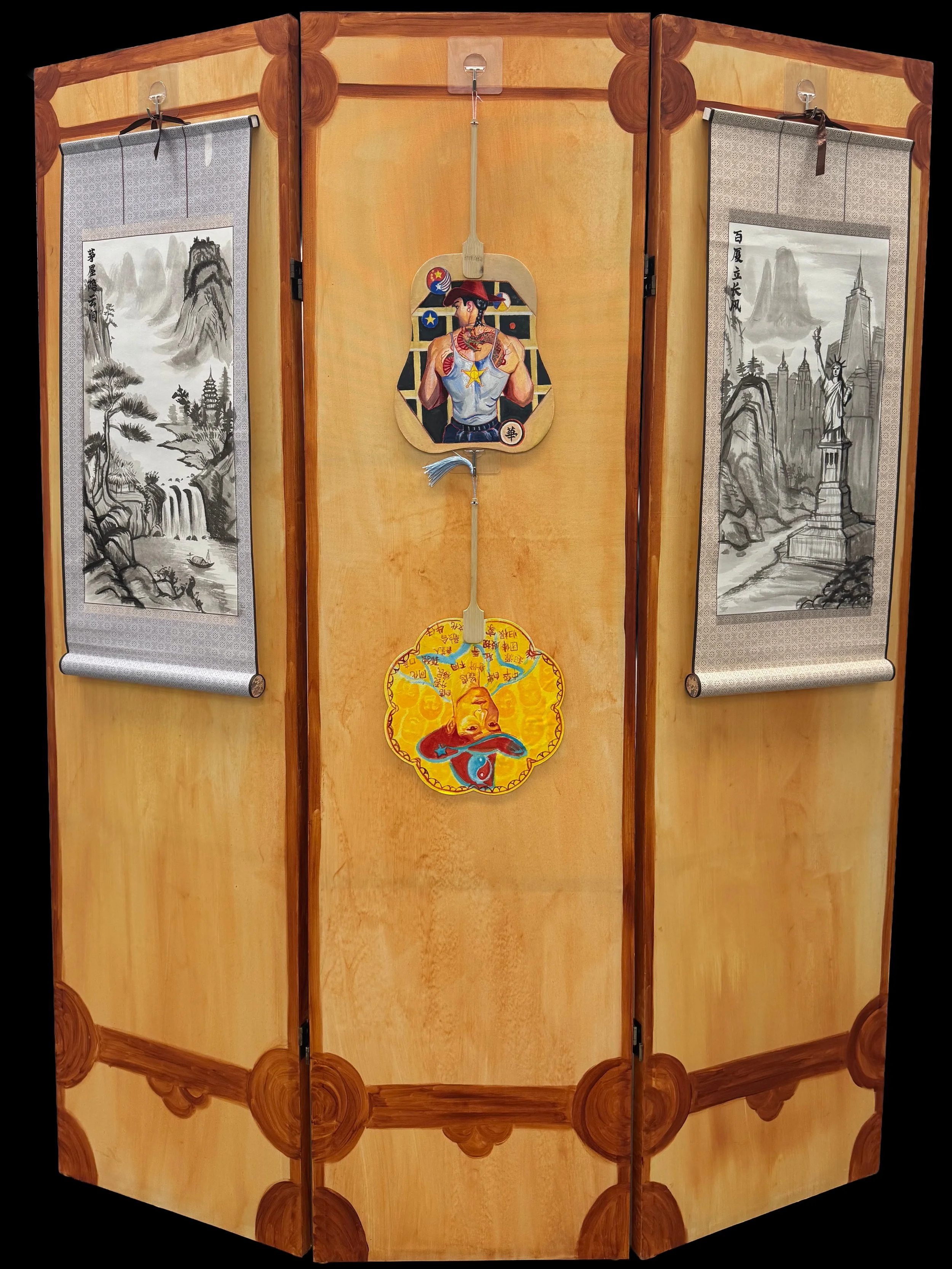 A wooden folding screen decorated with traditional Asian art. The screen features two black and white landscape paintings of mountains, waterfalls, and a pagoda on the left and right panels. The center panel displays a colorful illustration of a pers