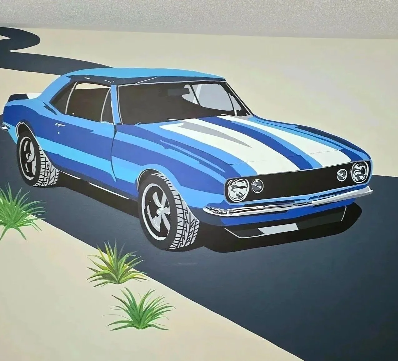 This mural is a fun take on realism, bringing solid pops of colour to create those iconic Camaro body lines