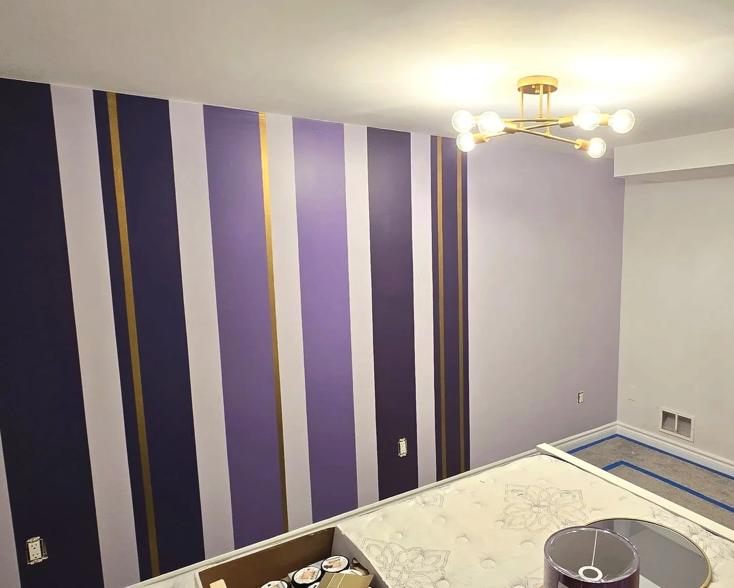 This purple accent wall makeover with metallic gold accents marked the transition into teen years for this young client