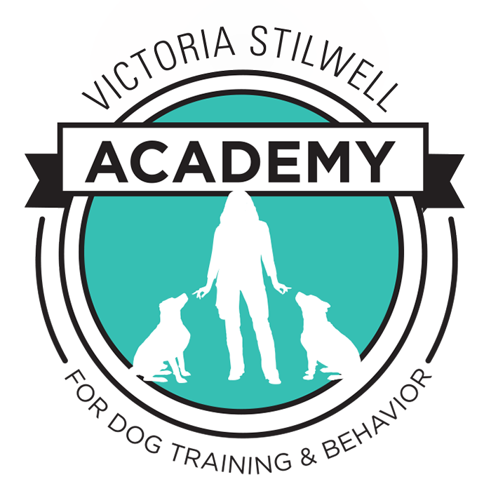 Logo for Victoria Stilwell Academy for Dog Training & Behavior, featuring text and a silhouette of a person with two dogs at their sides.