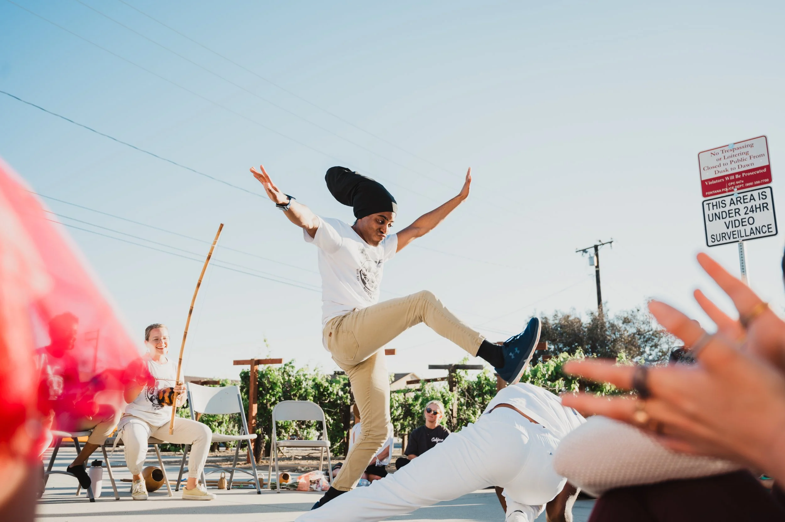 Members of N'gola Preto Velho, a school dedicated to sharing the art of Capoeira de Angola, perform capoeira at a community event in Southern California. 