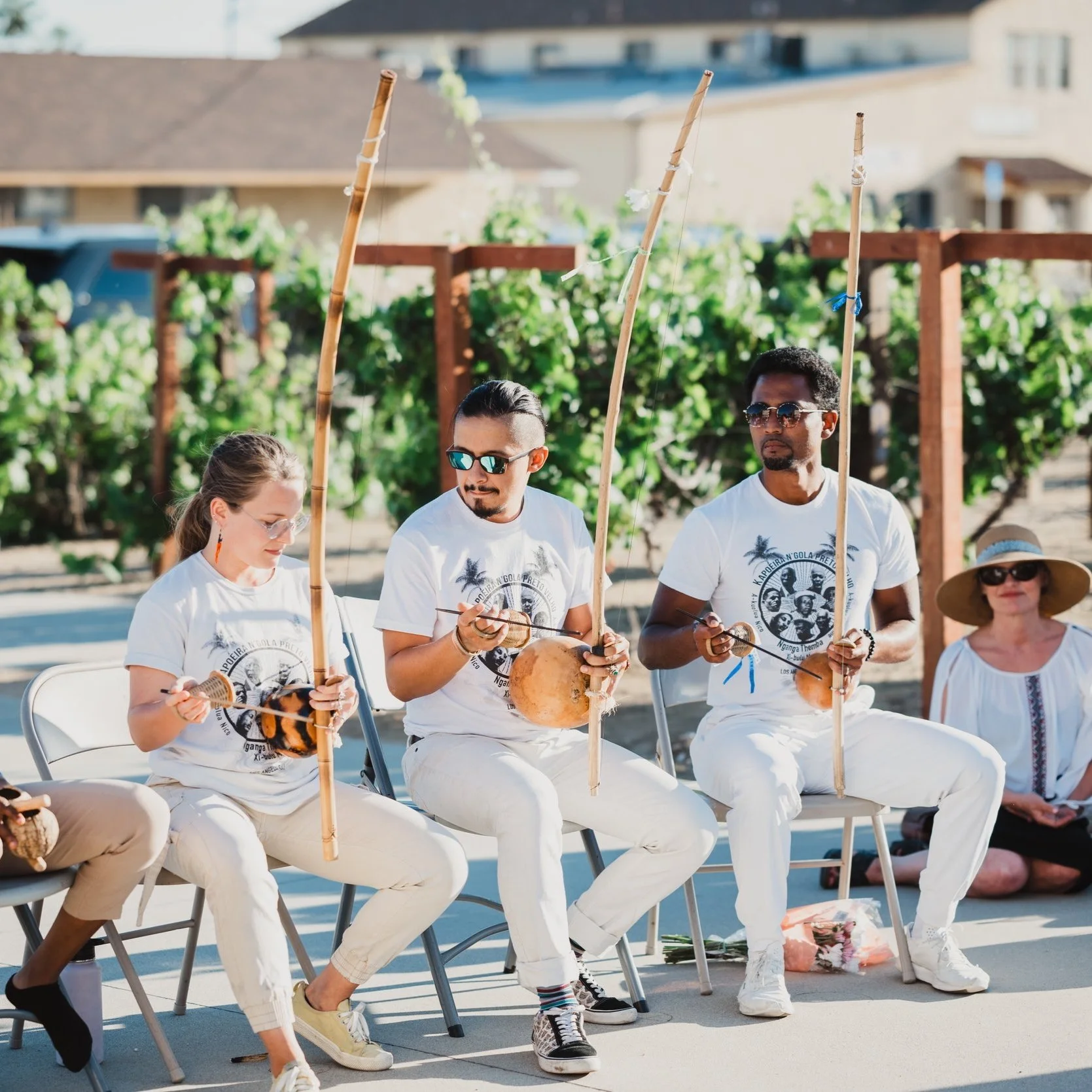 Members of N'gola Preto Velho playing berimbau in the batería during a Capoeira de Angola performance at a local community event in Southern California.