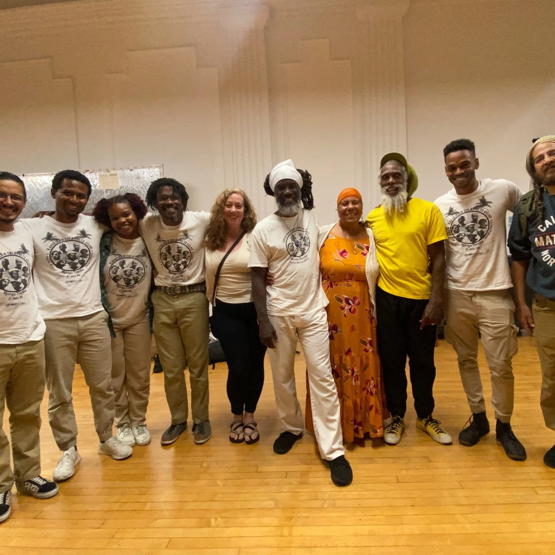 Mestre Themba Mashama poses with members of the N'gola Preto Velho community after a Capoeira de Angola roda, workshop, and performance.