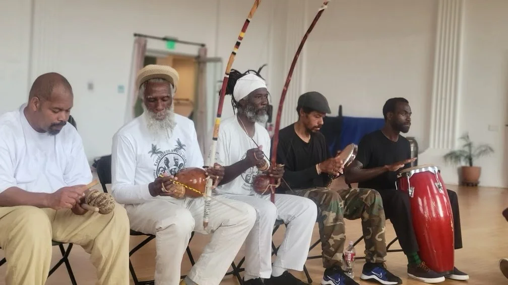 Mestre Themba Mashama and members of the N'gola Preto Velho school and community play berimbau and other traditional capoeira instruments in the batería at a Capoeira de Angola roda and performance in Southern California. 