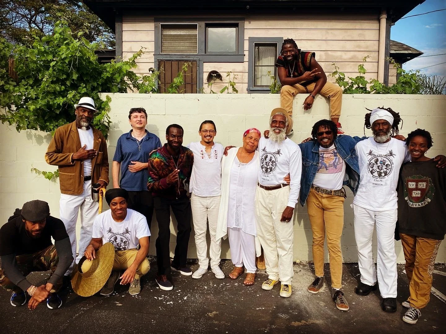 People pose for a "family photo" with Mestre Thema Mashama and members of N'gola Preto Velho, a school dedicated to sharing the Afro-Brazilian art and culture of Capoeira de Angola in Southern California. 