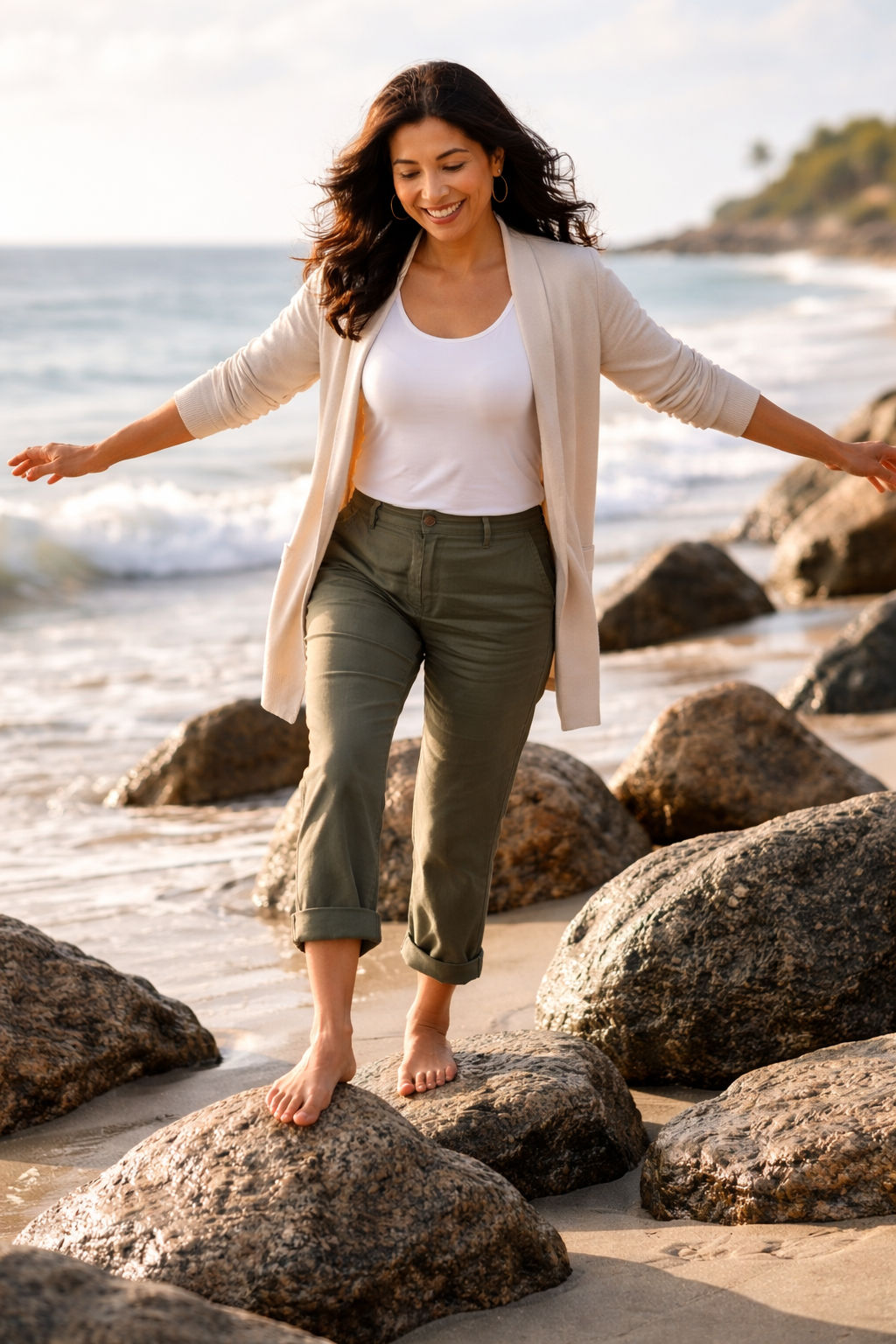 Middle aged women balancing on rocks at the beach