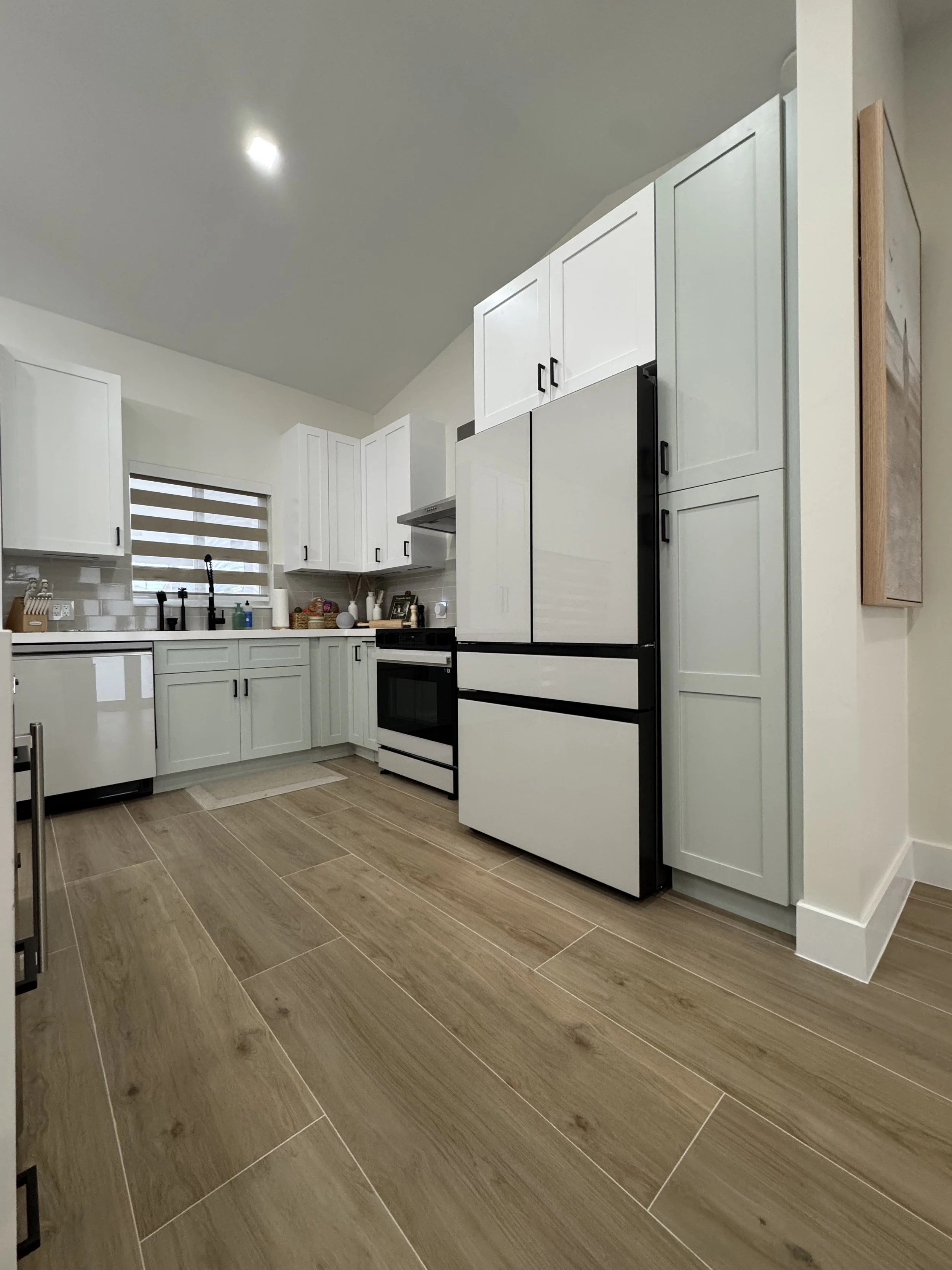 shaker customized kitchen with white and sage cabinets.