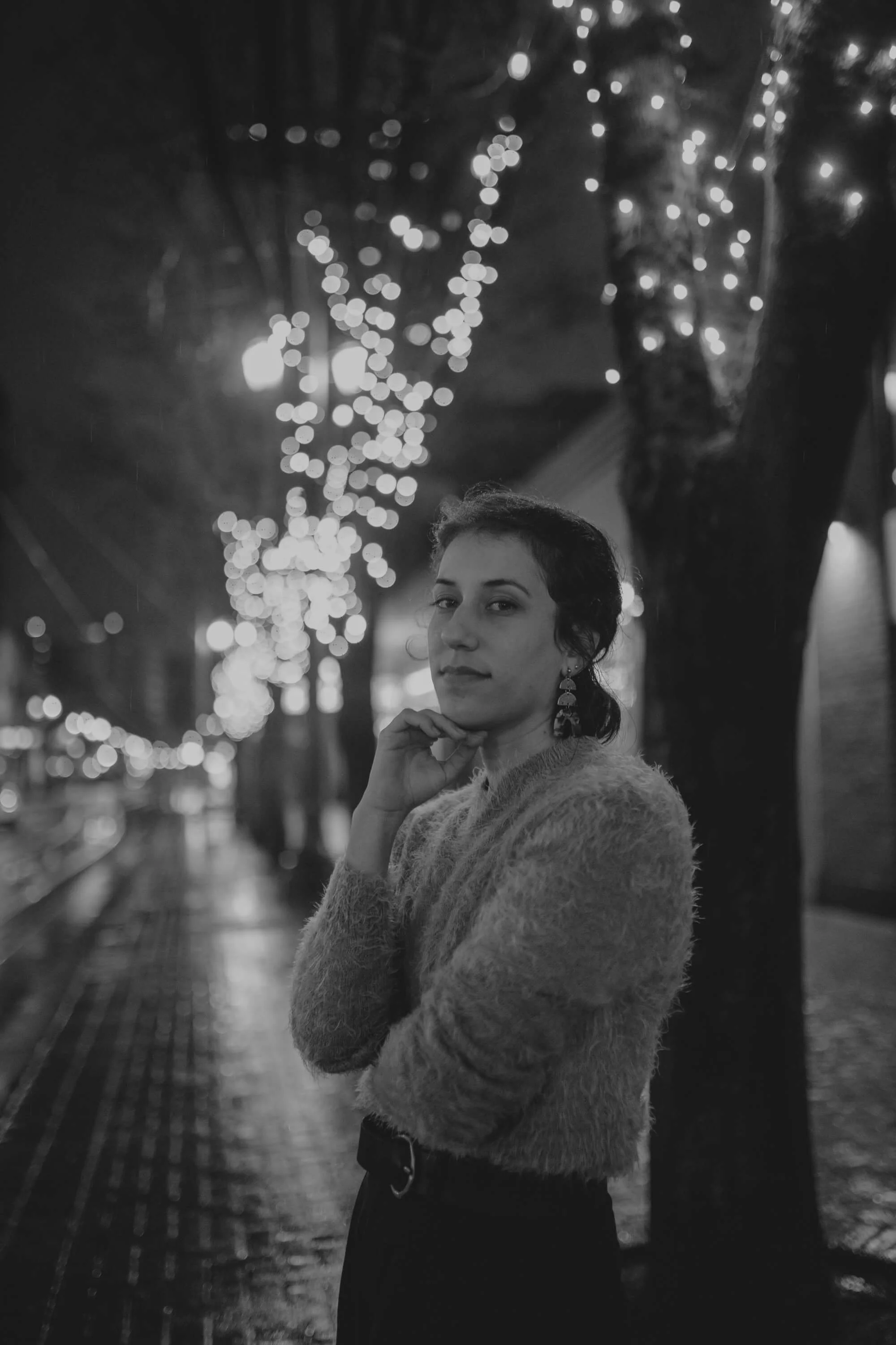 Nurse turned website copywriter and founder of Sleep Deprived Nurse, Bridget, standing on a brightly lit street