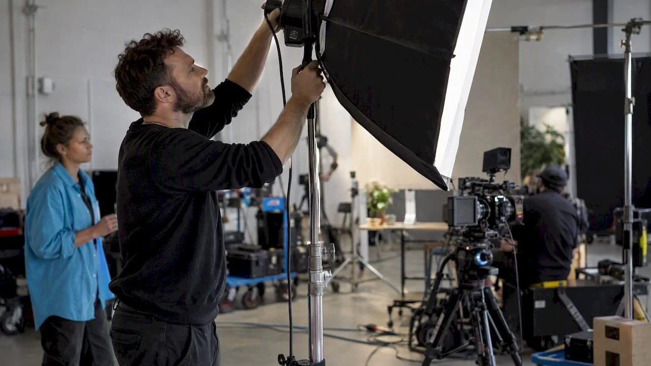 Alex directing controlled lighting during a commercial shoot on a Dallas set