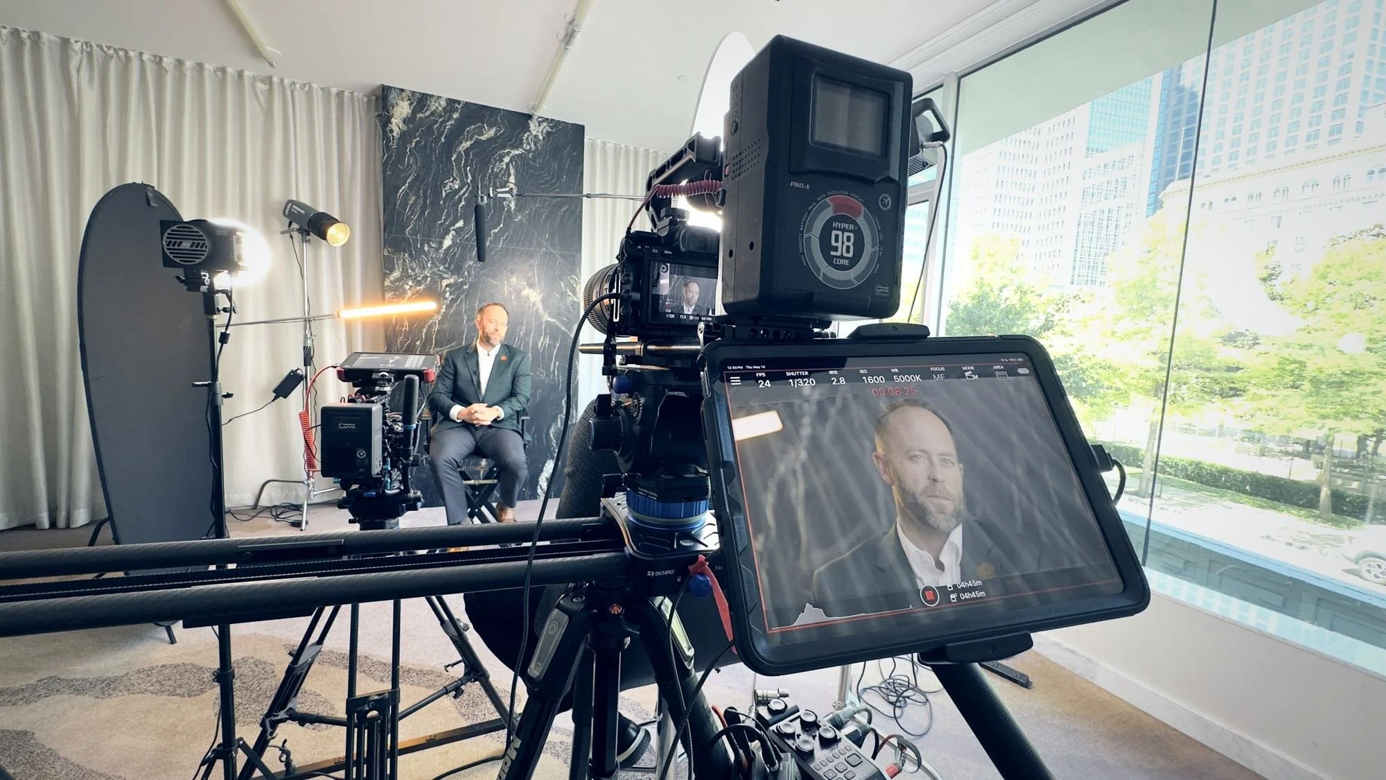 Dallas corporate videographer Alex Kinter filming an executive interview in a downtown Dallas office