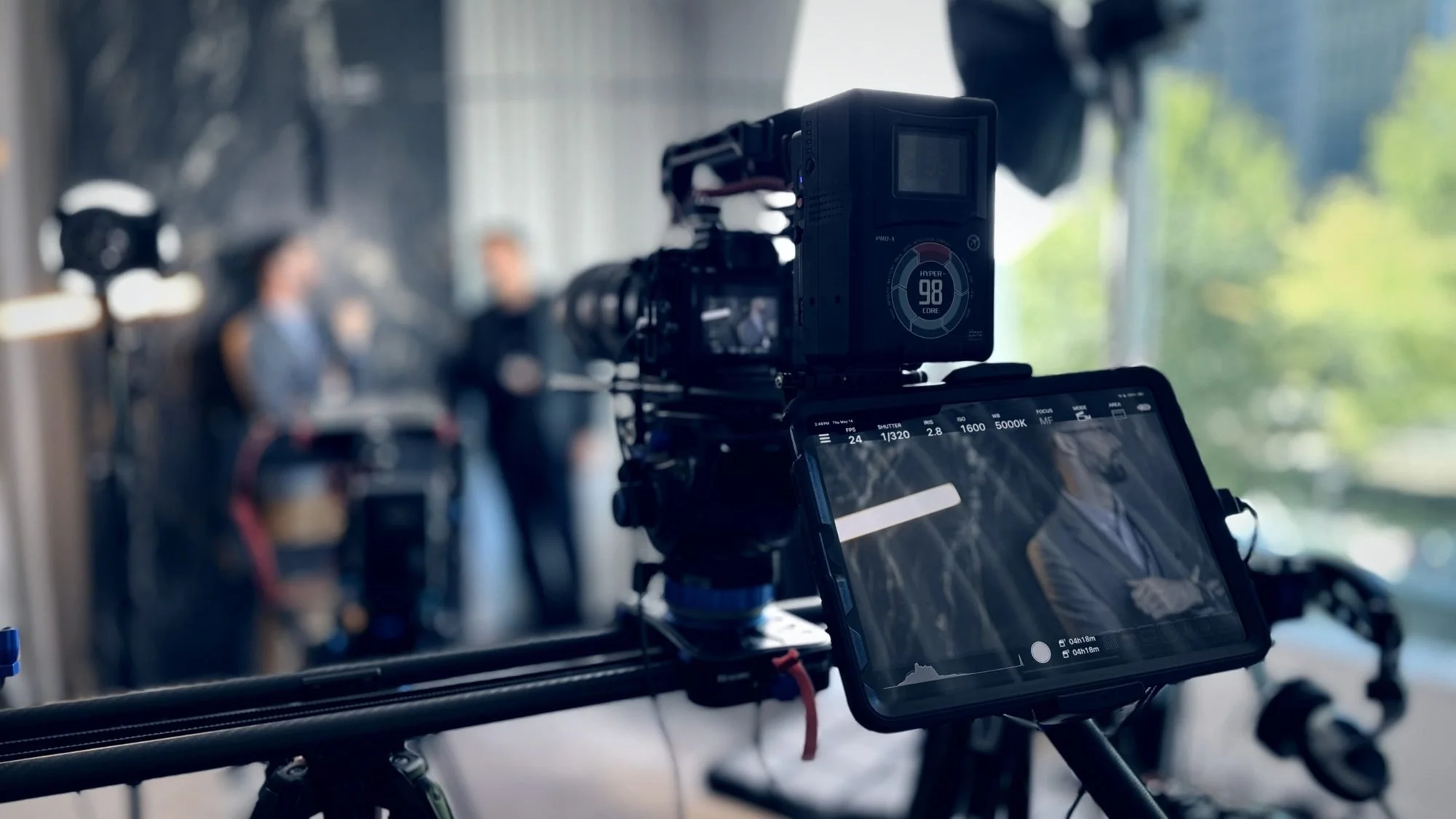 Camera slider rig on a corporate interview set in Dallas, operated by videographer Alex Kinter