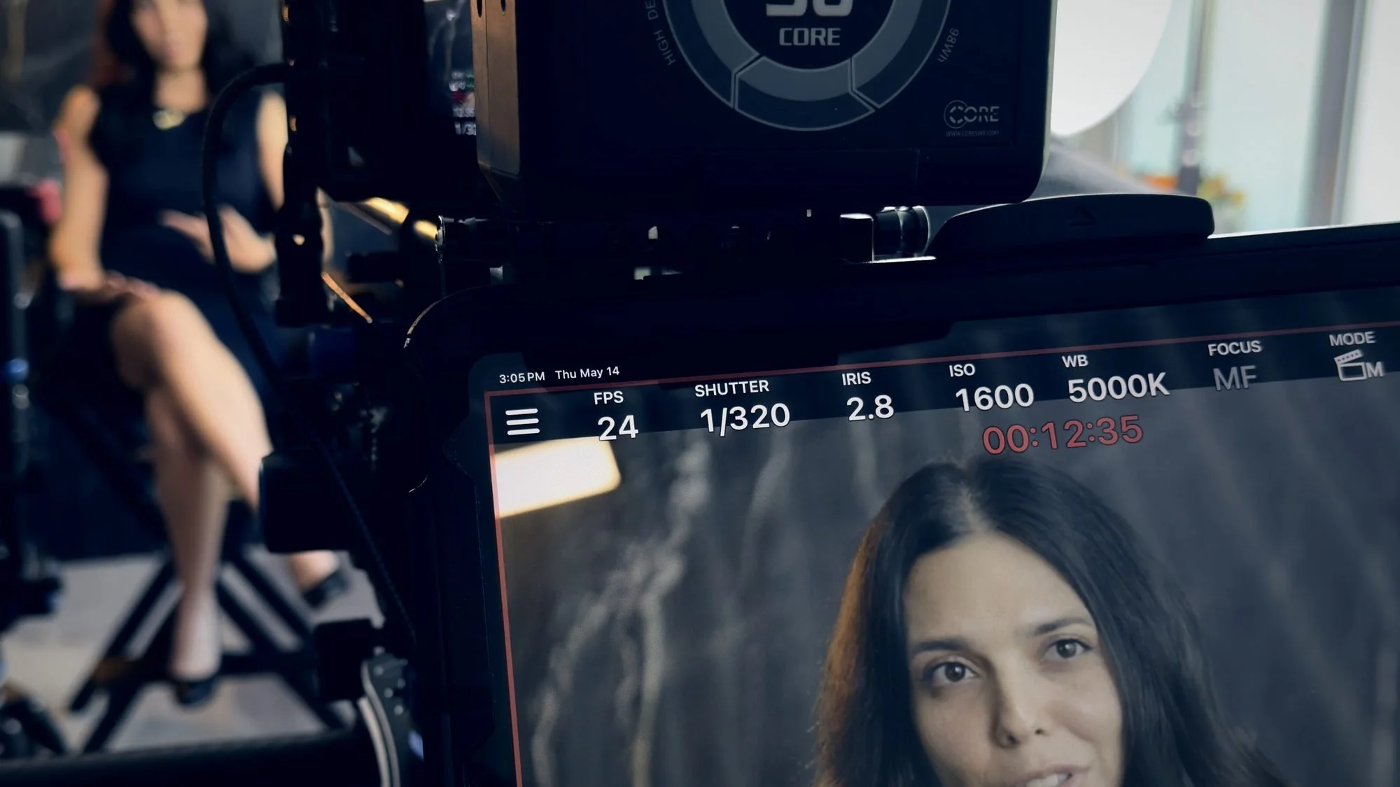 Dallas videographer Alex Kinter framing a brand interview on the camera monitor