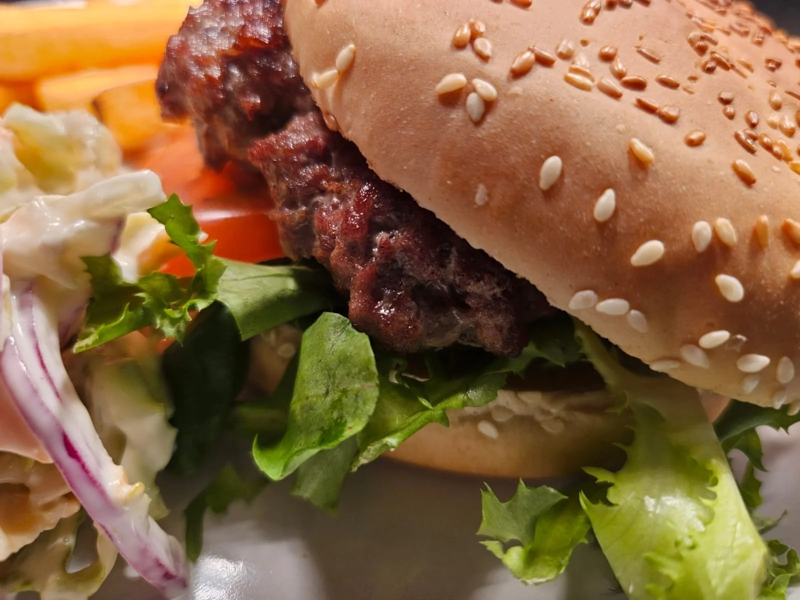 Homemade Beef Burger in a Seeded Bun with Chips, Salad and Homemade Coleslaw
