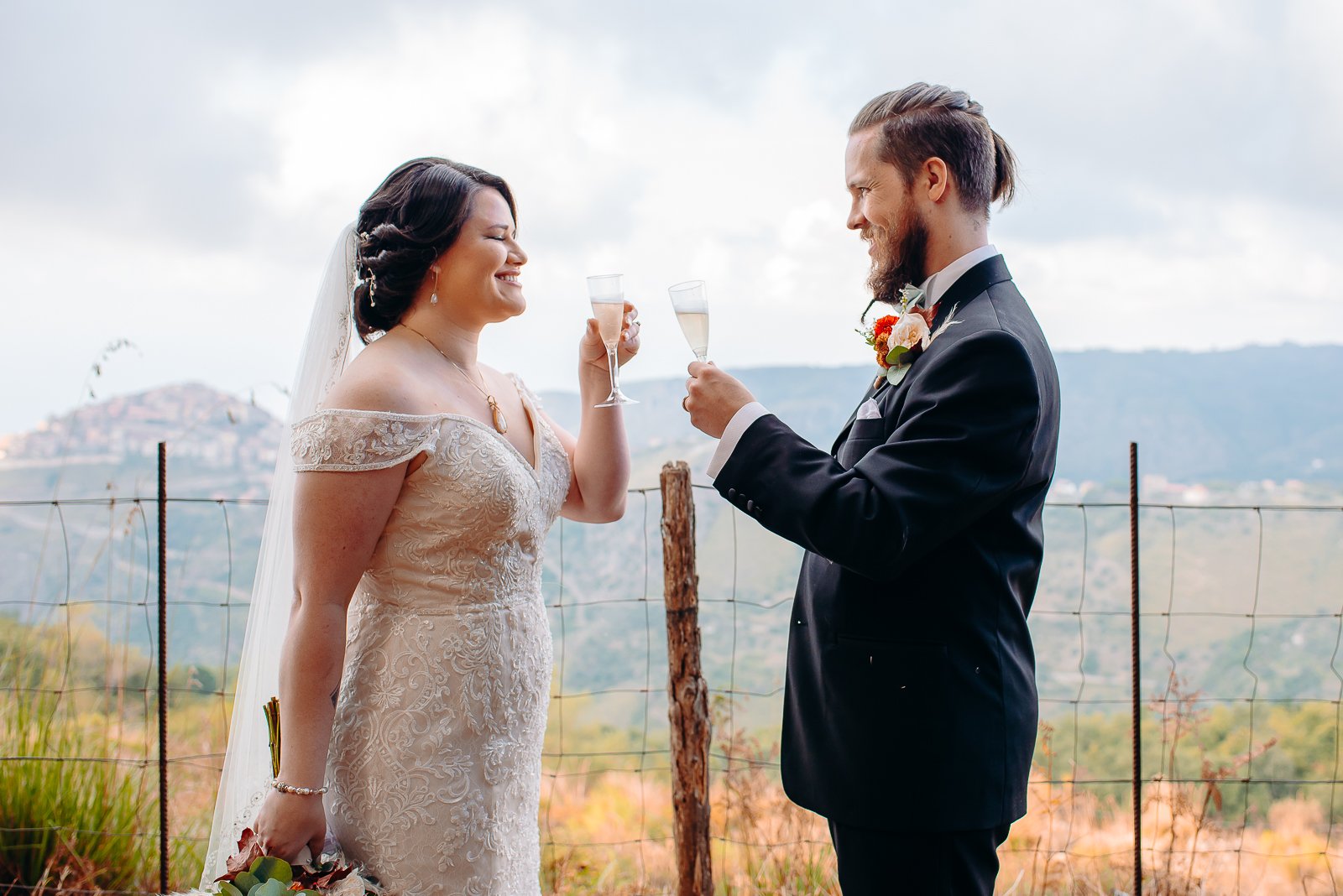 Bride and groom on wedding day toasting after their ceremony in Sicily, Italy