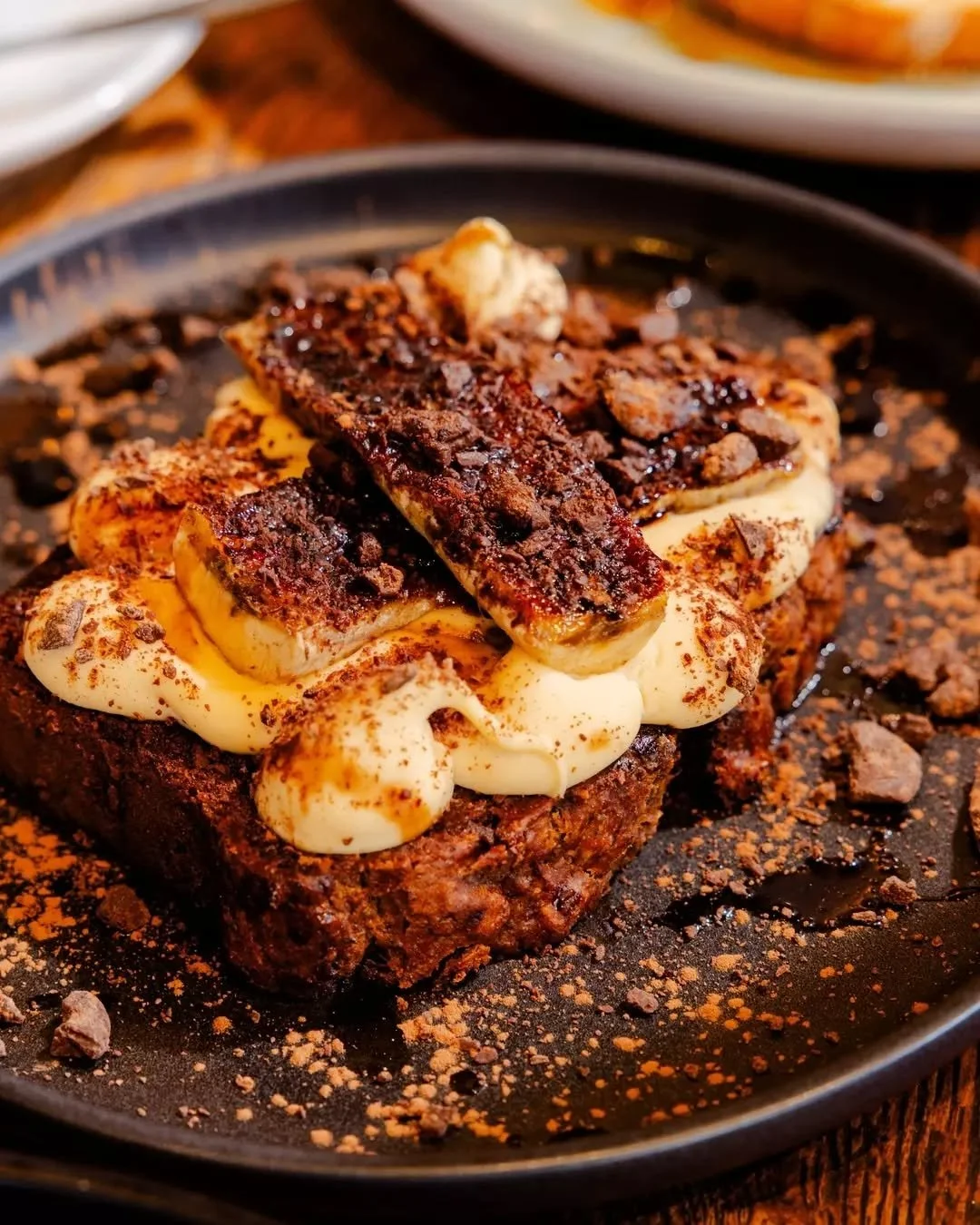 Tiramisu, but make it brunch. ☕&nbsp;Our tiramisu banana bread comes with mascarpone, coffee syrup, grilled banana, and a touch of dark chocolate.