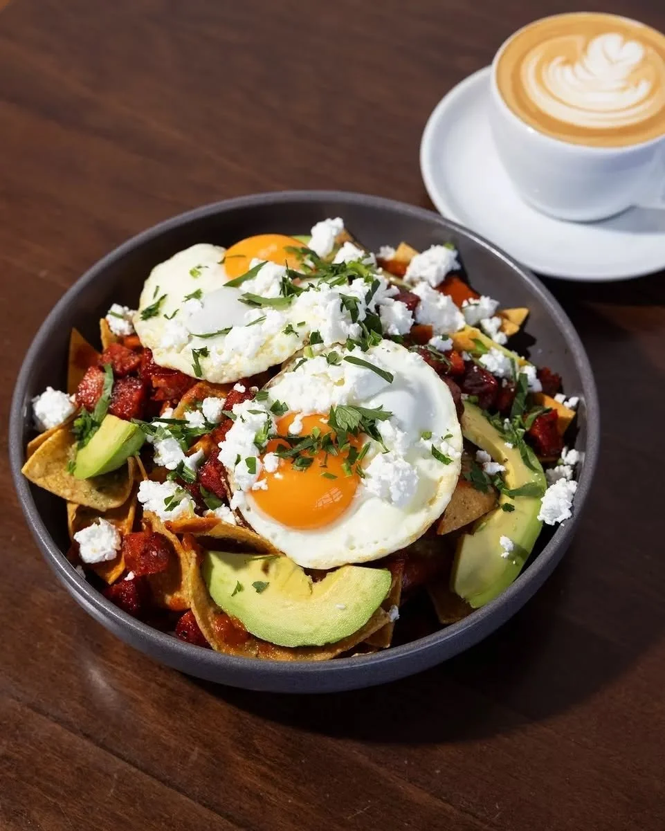 A traditional Mexican breakfast you need to try. 🤤 Corn tortillas, tomatillo salsa, chipotle sauce, feta, chorizo, sliced avocado and sunny side up eggs.