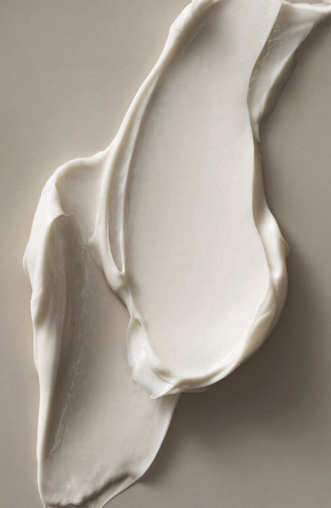 Close-up of white plaster or clay with smooth, flowing textures, resembling abstract art or a sculptural piece.