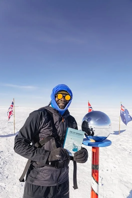 Dwayne Fields holds his copy of The Ice Sonnets, published by Dithering Chaps press, at the South Pole