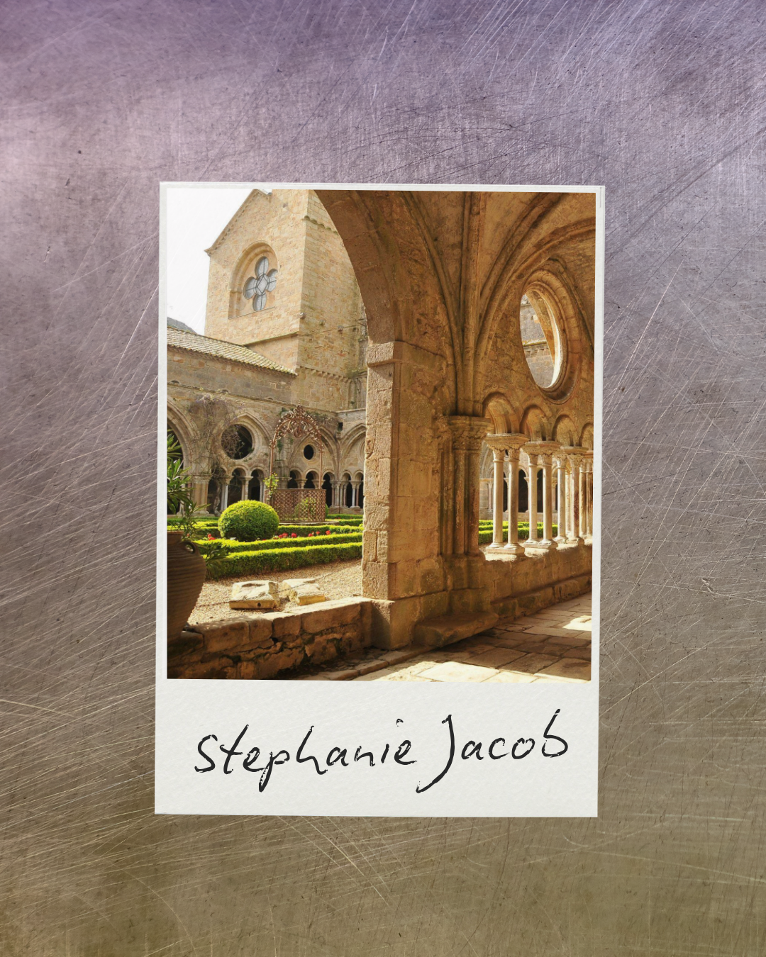 A photograph of a historic stone church with arched windows and a garden courtyard, viewed from a covered walkway with stone columns and round windows, and the name 'Stephanie Jacob'.