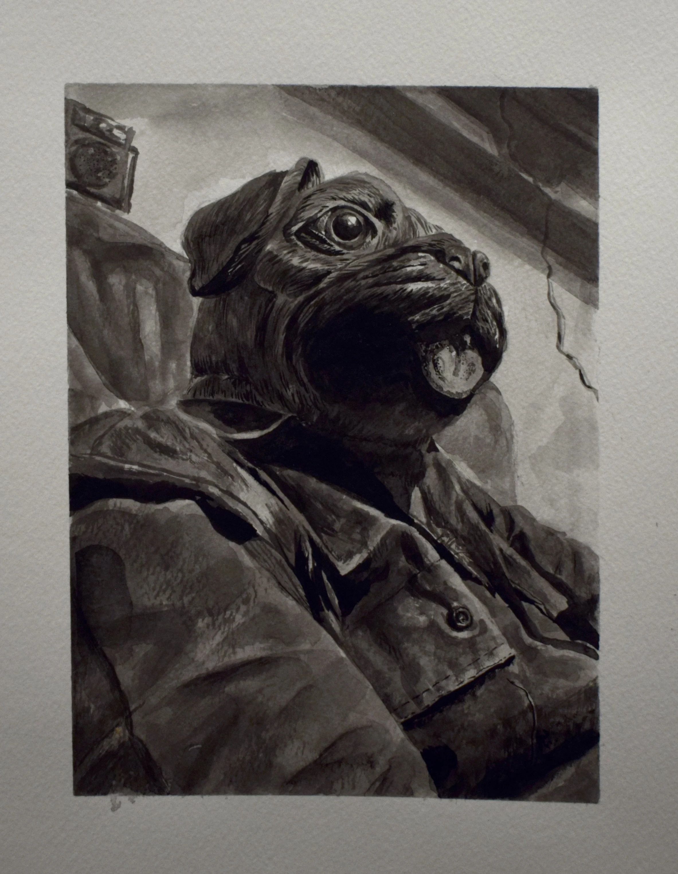 Black and white portrait of a dog with an expressive face, resting on a couch, with a wall and a small audio speaker in the background.