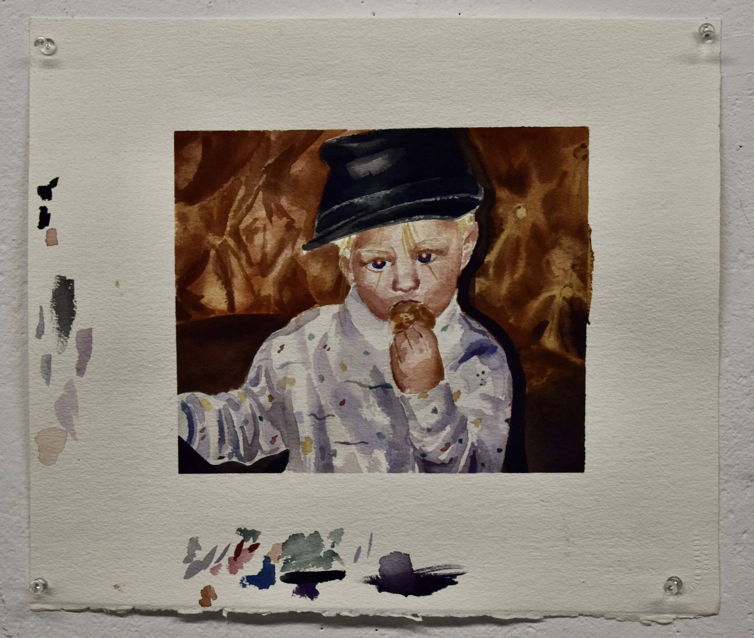 A watercolor painting of a young child with blond hair, wearing a dark cap and a light, patterned shirt, eating a chocolate ice cream.
