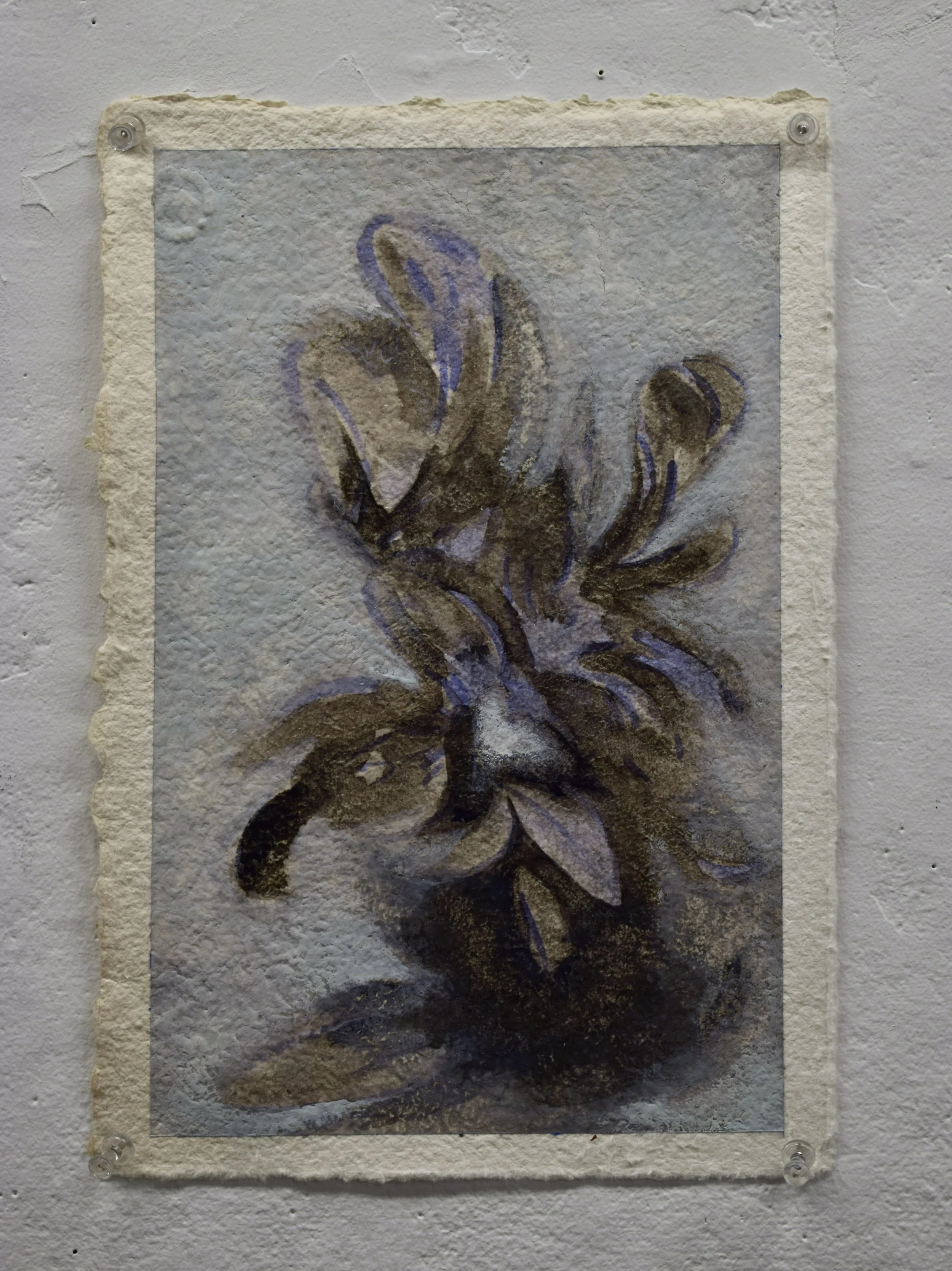 A textured painting of leaves and plant stems mounted on a wall.