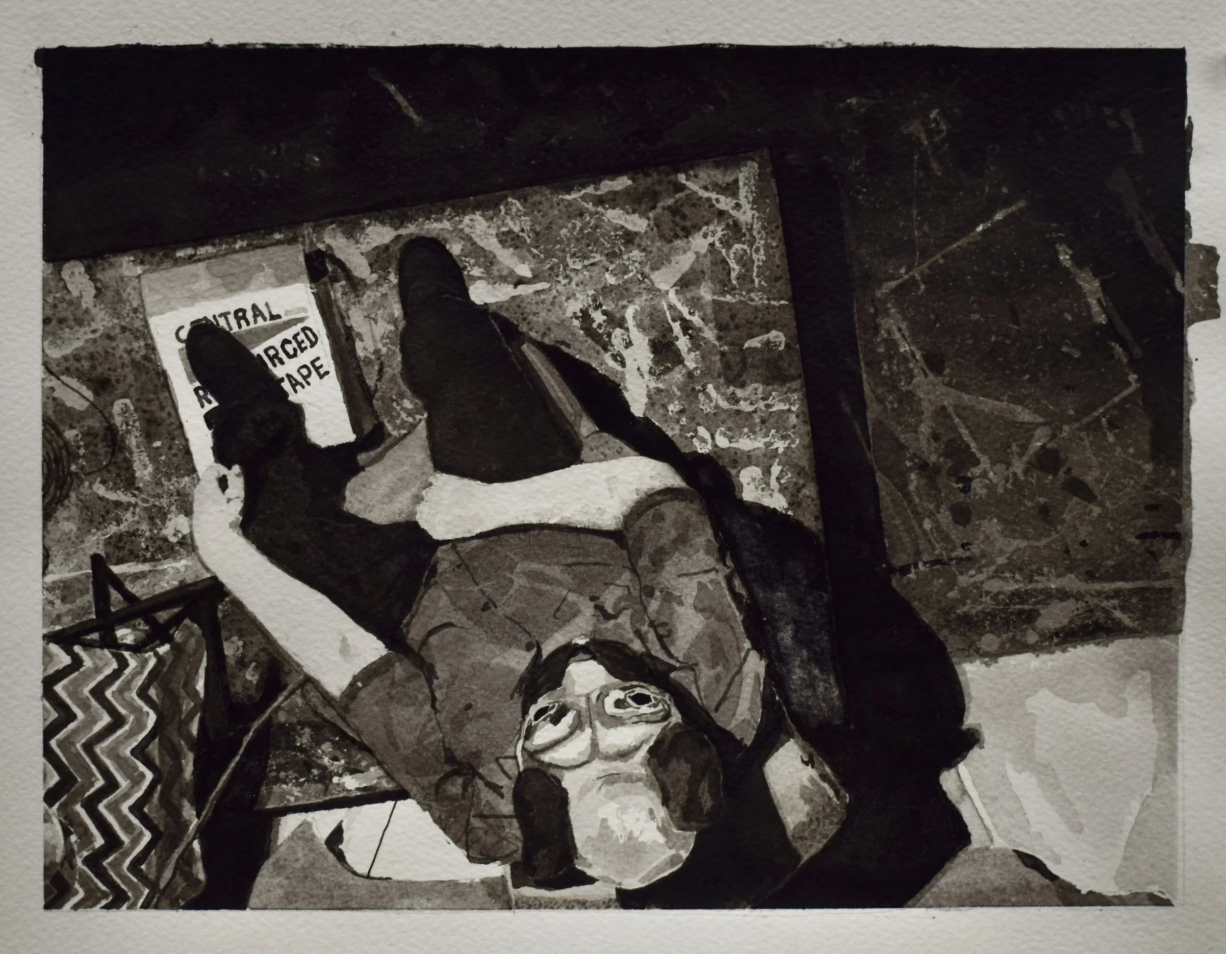 A person lying on the floor, looking up at the camera, with a sign that reads 'Central Regulated Tape' nearby. The person is wearing glasses and casual clothing. The floor has a marble pattern, and parts of decorative elements are visible in the corn