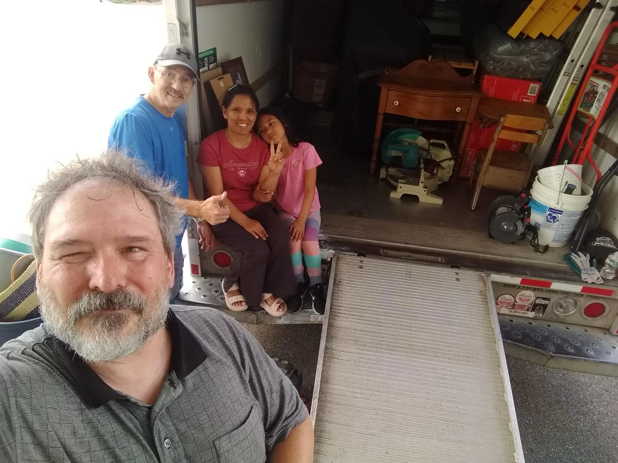 Welcome Home! New mover, Glenn, and his family receive a helping hand as they unload their truck into their new home.