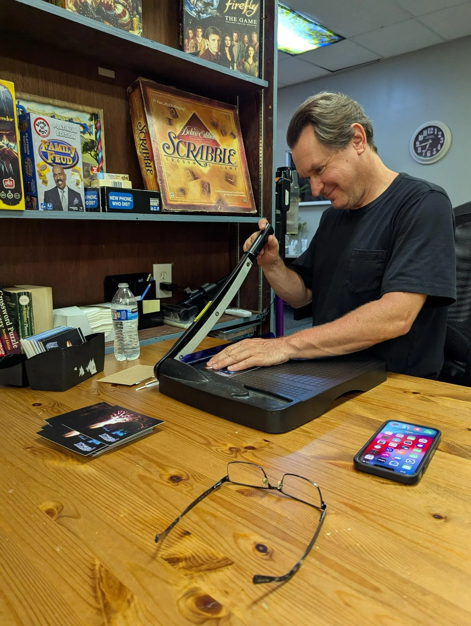 Volunteer party moments. During our monthly volunteer night at the Quill, Robert Daniel cuts PorcFest postcards to prepare for an upcoming mailing.