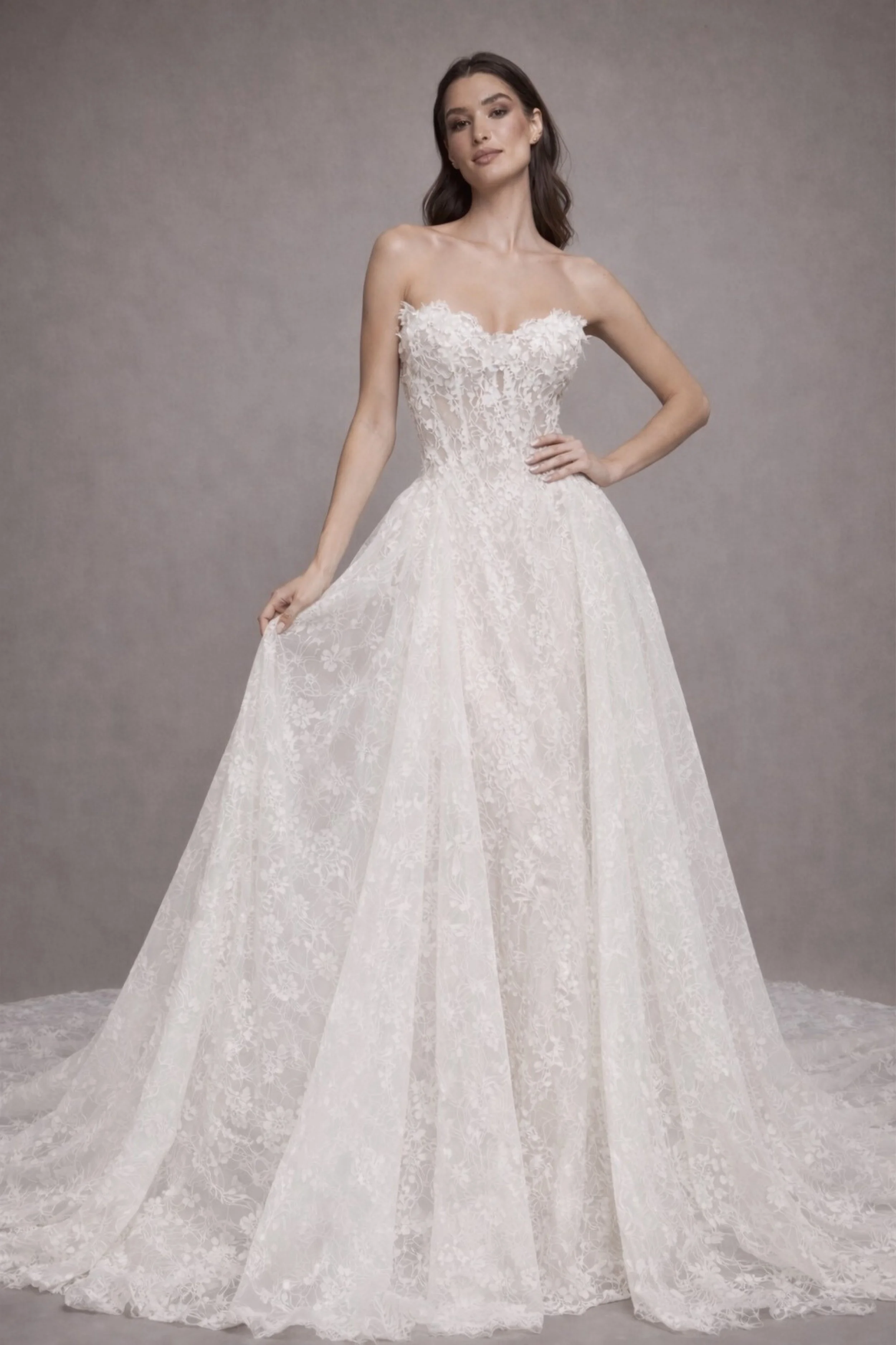 Open back lace A-line wedding dress with floral details and flowing train, romantic bridal gown